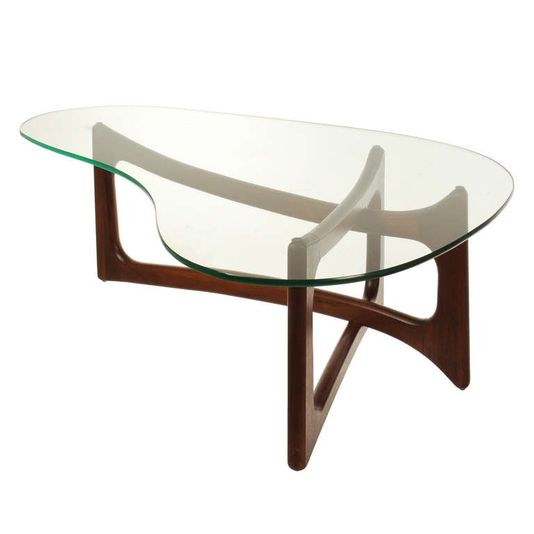 Elegant and stylish cocktail table by designer Adrian Pearsall.  The large kidney shaped glass rest on a solid walnut sculptured base. Manufactured by Craft and Associates, this piece retains its original oil rubbed finish, bringing out the
