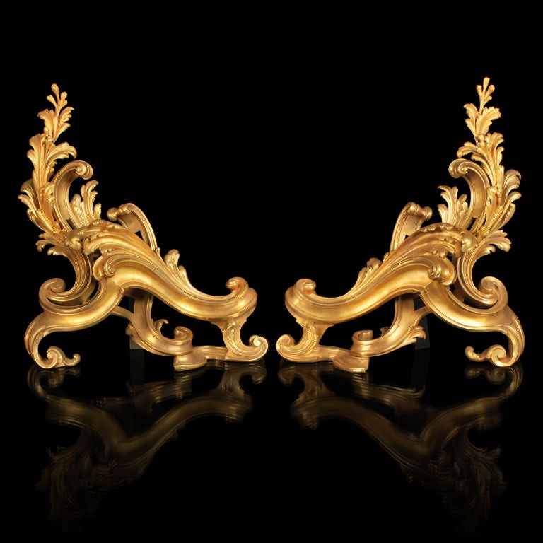 This is a stunning pair of large scale Louis XV Style Gilt Bronze Chenets. They are absolutely superb examples of French craftsmanship and quality. The elegant Rococo style with its flowing acanthus leaf design and curled scrolls are finished off in