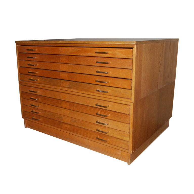 This is a very nice vintage oak flat file with 10 drawers on a pedestal base. The cabinet is made up of two 5 drawers cabinets with a separate top and base. The long drawer glides allow the drawers to open and close very easily.<br />
This is