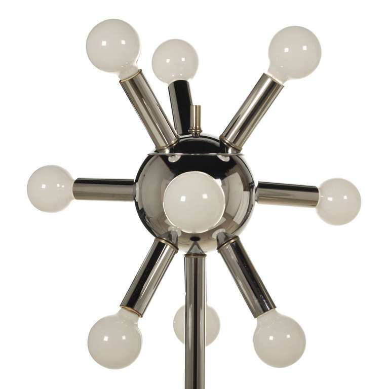 Fantastic chrome Sputnik floor lamp from the the 1950's-1960's era. All original, this vintage floor lamp holds nine bulbs and has a black accent floor base. The lamp switch is a three-way switch, mounted on the globe, and allows you to light 3