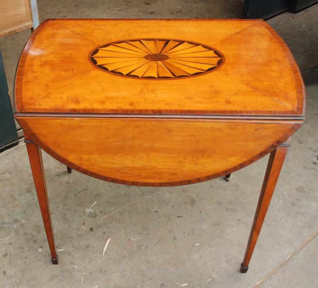 George III Pembroke table with inlaid top and drop-leaves, one working and one faux drawer, sitting on tapered legs.

19 1/4w (opens to 38 3/4) x 30 1/4d x 28 1/4h