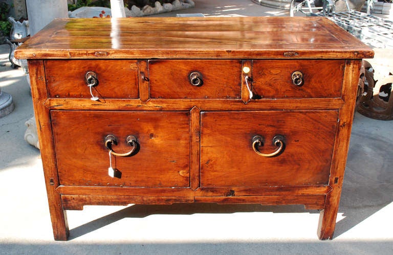 A Chinese unusually large, deep chest with three short drawers over two long drawers, having its original hardware. 