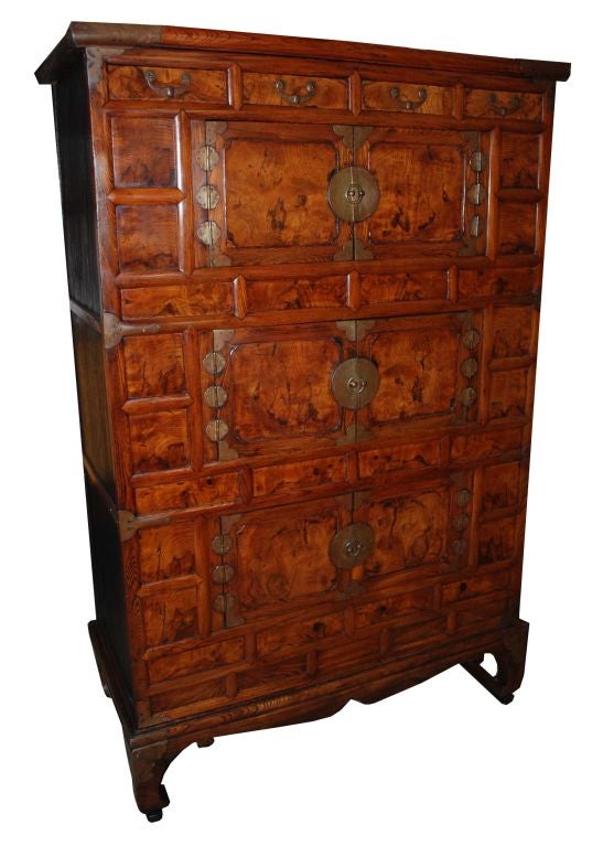 Korean Kitchen cabinet with decorative hardware, four short drawers above three sets of doors, sitting on shaped frieze and feet.