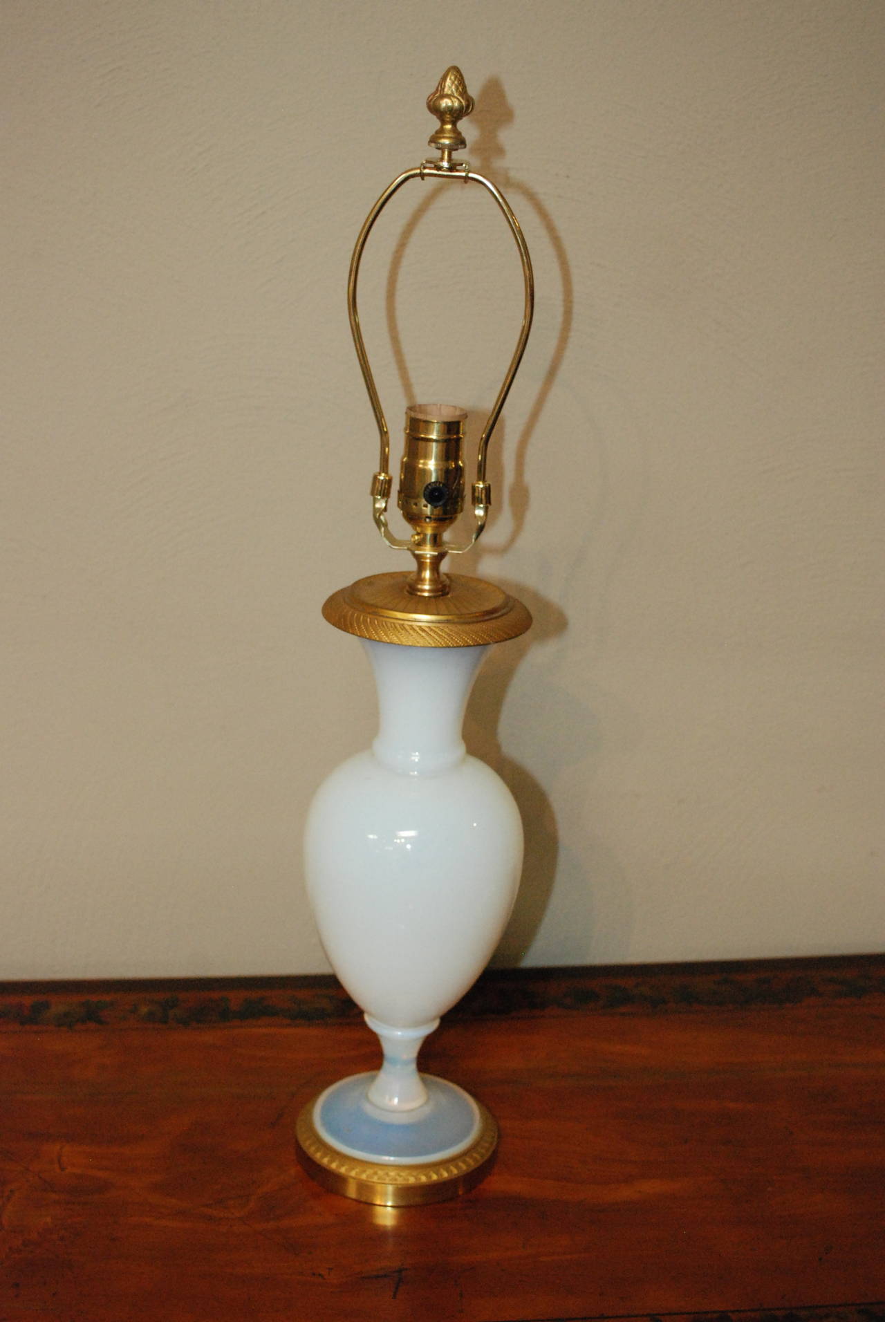 Pair of French Opaline lamps with gilded base and top.

Shades not included