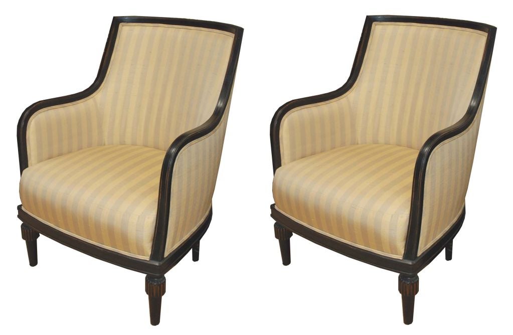 Chair with exposed frame, a tight-back and loose seat cushion, sitting on tapered, turned legs.