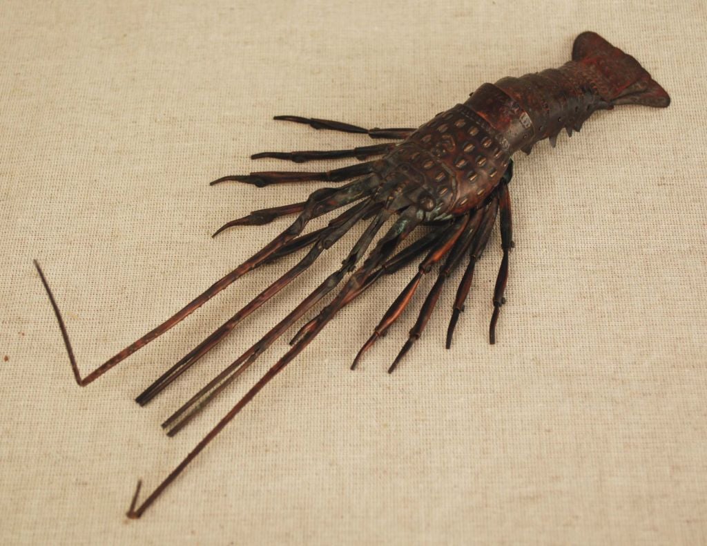 An exceptional Japanese articulated copper crayfish (Ebi) with fully articulated legs, antennae and tail segments. Signed on the underside.<br />
<br />
During the Meiji period, when sword making was restricted, Japanese artisans turned their