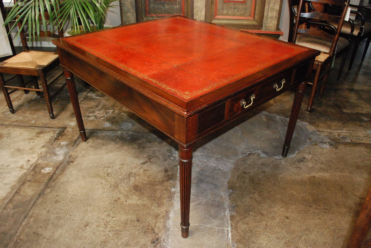 English mahogany partners desk 
with original embossed red leather.