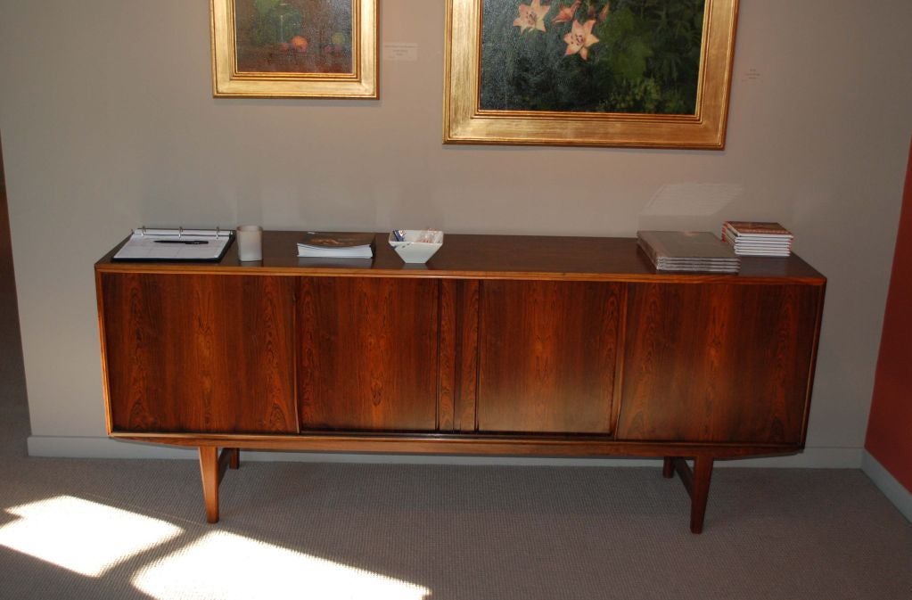 Danish modern sideboard with dramatic wood grain, having four doors enclosing four stationary shelves.
