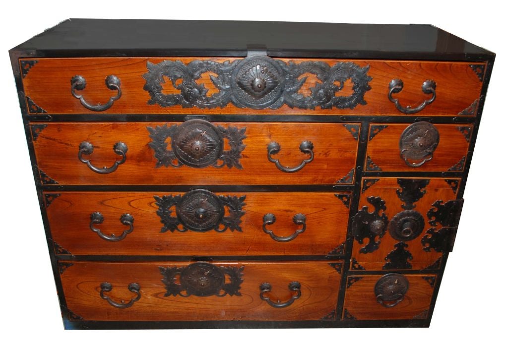 Japanese tansu with decorative hardware, six drawers, one door enclosing drawers.