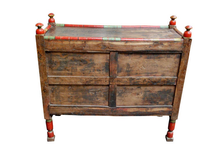 A Pakistani painted dowry chest with two centered doors enclosing one shelf, having an exterior latch and metal hardware.

Painted wood. Fine antique condition with normal wear for age and use.