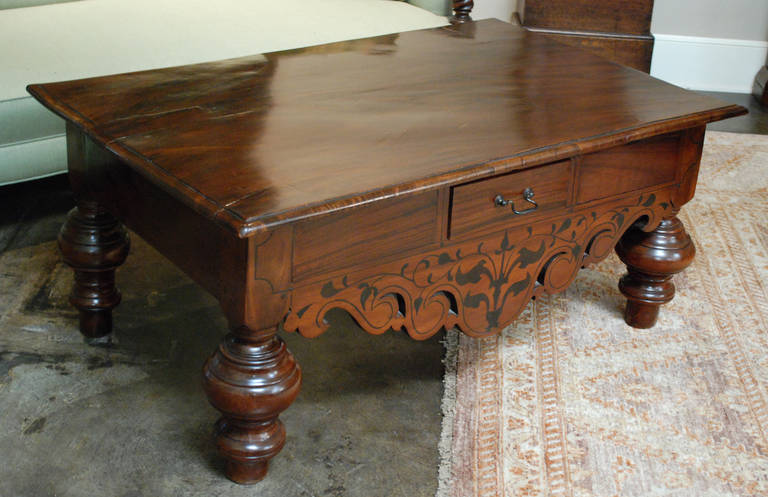 19th c. British colonial from Sri lanka coffee table with inlaid exotic wood. Vine design on front sitting on raised turned legs.