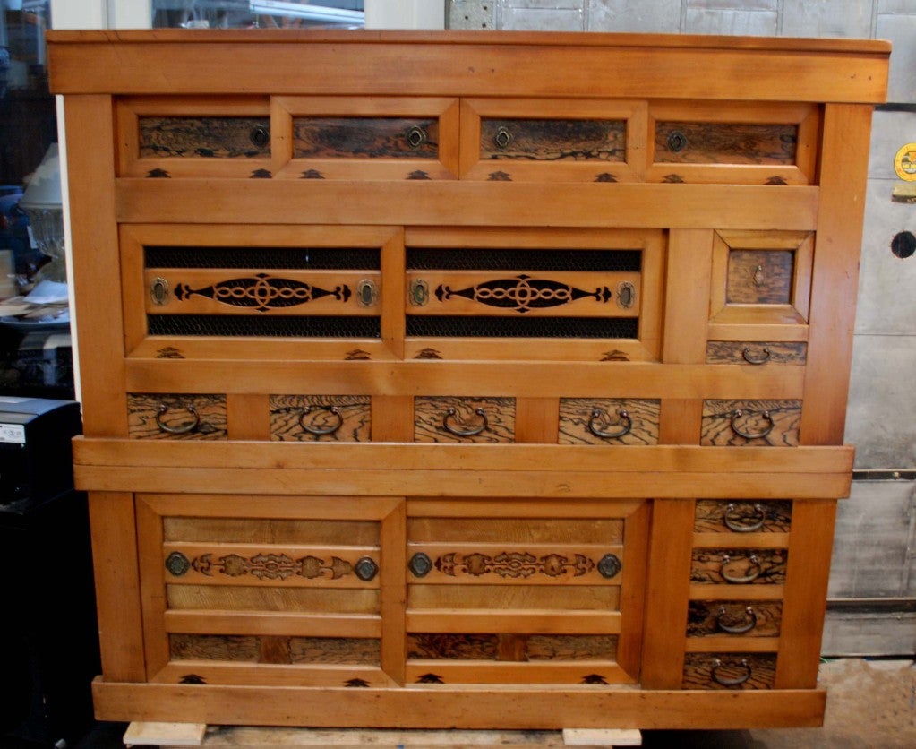 A finely crafted large Japanese kitchen tansu “mizuya dansu” with nine doors and ten drawers traditionally used to store kitchen items and tea wares. Writing on backboard reads
