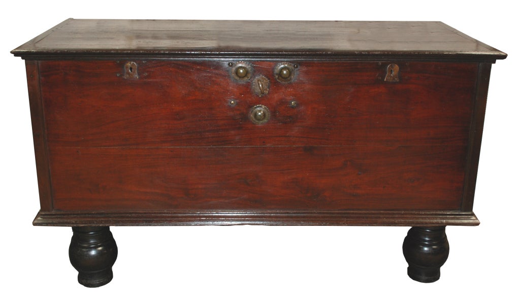 British colonial large trunk with impression, heavy iron hardware, sitting on raised legs.