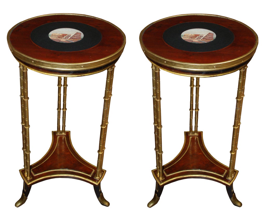 A pair of French tables with micro-mosaic inlaid tops and gilt-bronze legs and a lower inlaid shelf.