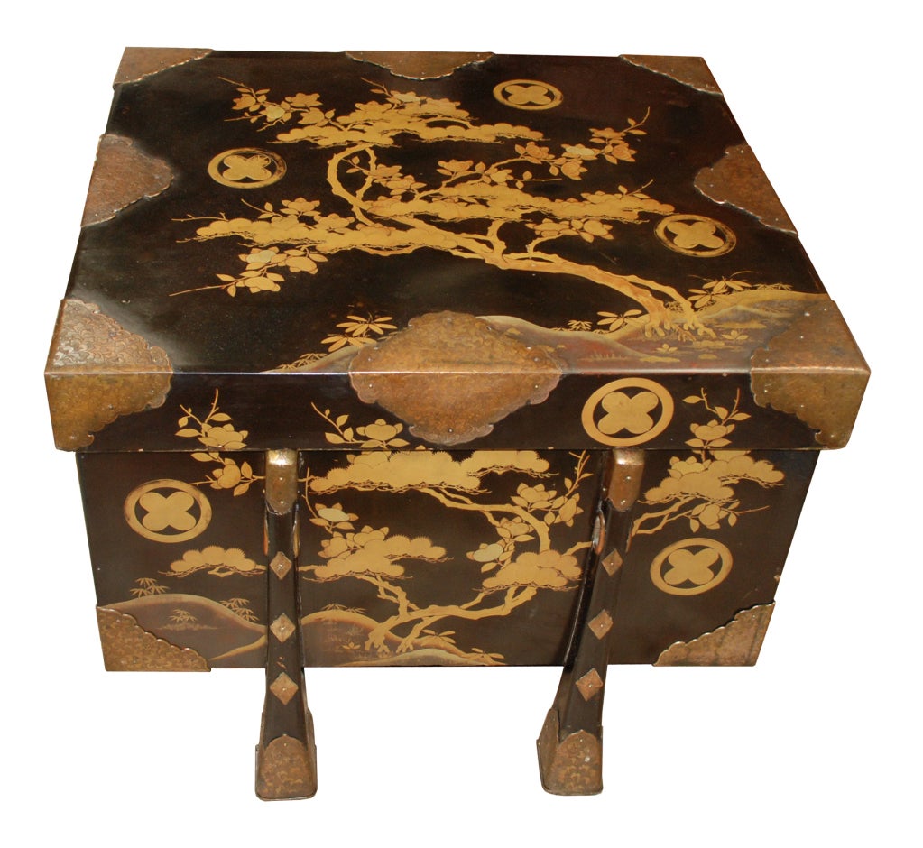 A Japanese black lacquer Chinese-style six-legged chest used for the storage of Samurai armor, having a “Maki-e” lacquering of sprinkled fine gold and or silver powder, small brushes or bamboo tubes were used to create highly detailed and intricate
