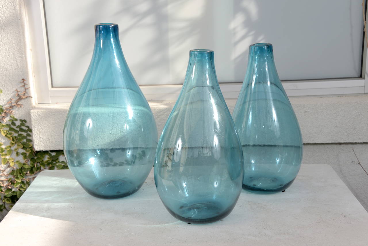 Vintage decorative blue glass vases.

Teardrop vase with baluster top with baby blue patina.

Origin: Paris, France, circa 1950s. 

Four sold separately.
