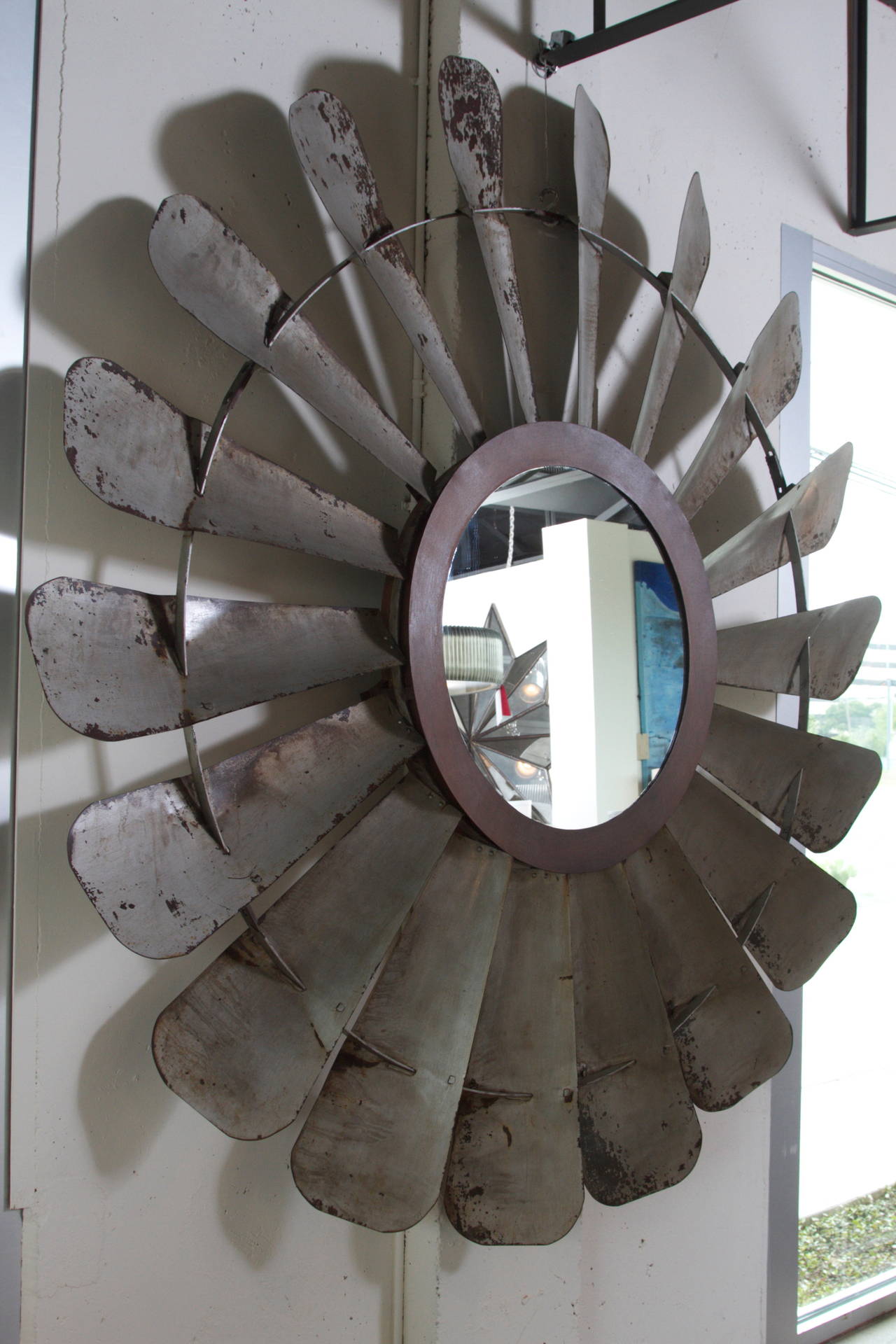 Vintage Tole Windmill Face as Mirror Frame
Large Windmill Face Mirror
Crafted from a 1950's windmill face, the blades have been shaped and cut to create a softer more refined aesthetic.
The center section, connecting the face to the tower,