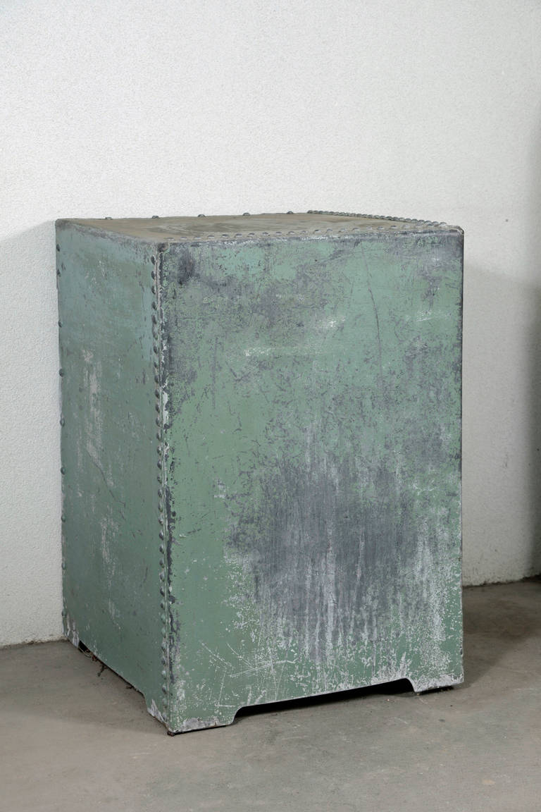 English galvanized displayed pedestal.

Repurposed from a vintage galvanized storage bin with natural aged distressed faded army green coloration. Three- sides exposed with rivets along the edges and cut-out on the back side to sit along side wall