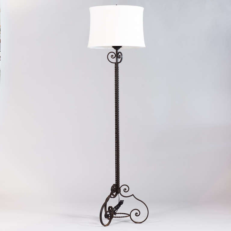 A 1940's Floor Lamp in black forged iron with twisted columns and scrolled feet. The actual shade is 18