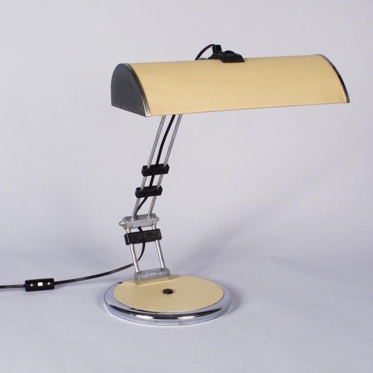 A vintage French Desk Lamp made of chrome metal and leather. The articulated stem provides adjustable height.