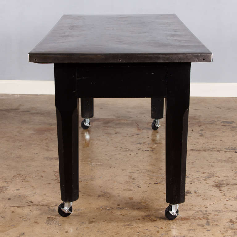 A great working table from a restaurant in Lyon that was painted in distressed black and with a stainless steel top. The table has 2 large drawers in the apron and rolls on casters. A perfect kitchen island! From floor to apron: 25