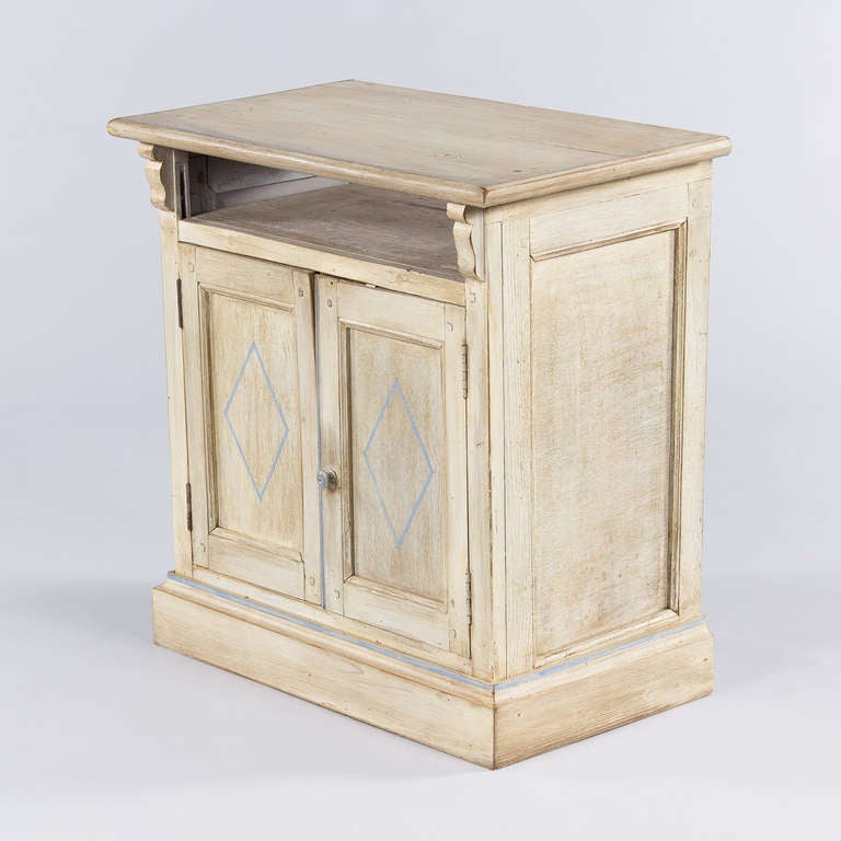 A small 2-door Cabinet from Provence painted off-white with light blue trim.  The Cabinet has a shelf inside and an open niche under the top. A perfect piece for a TV, for the side of a bed or at the end of a sofa.