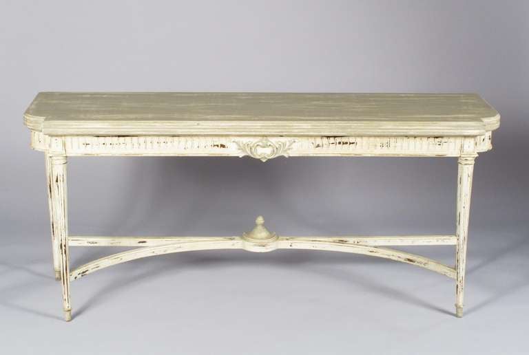 French Louis XVI Style Console Table in off-white and grey tones on solid oak. This beautiful table features fluted legs, fluting on the apron, a curved stretcher with a toupie finial and hand carved motifs with acanthus leaves. A strong statement