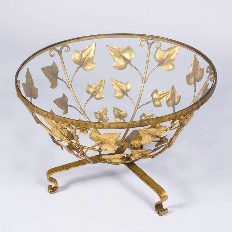 A fabulous 1940s French Gilded Tole and Glass Table featuring a gilt metal base with hand chiseled leaf design. Perfect for a coffee or side table!