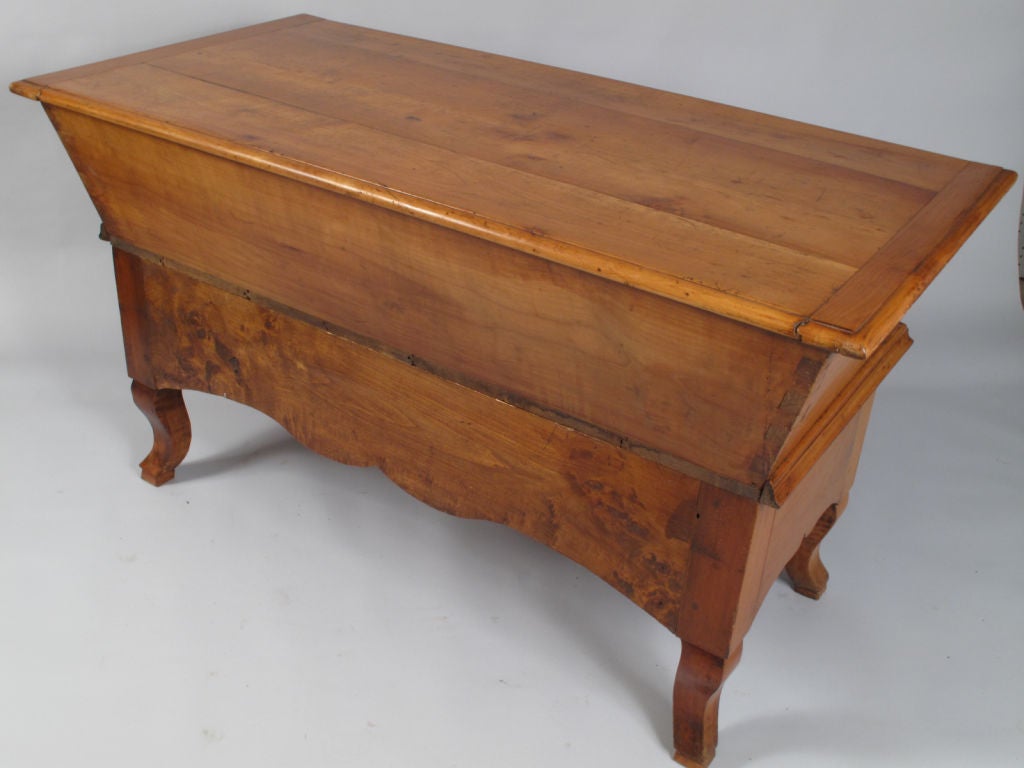 This fabulous Louis Philippe Dough Bin (Petrin) comes from the Island of Corsica. It is made of gorgeous cherry wood, rests on curved legs and has 3 drawers above the scalloped apron.  The upper part separates from the base and the top slides to