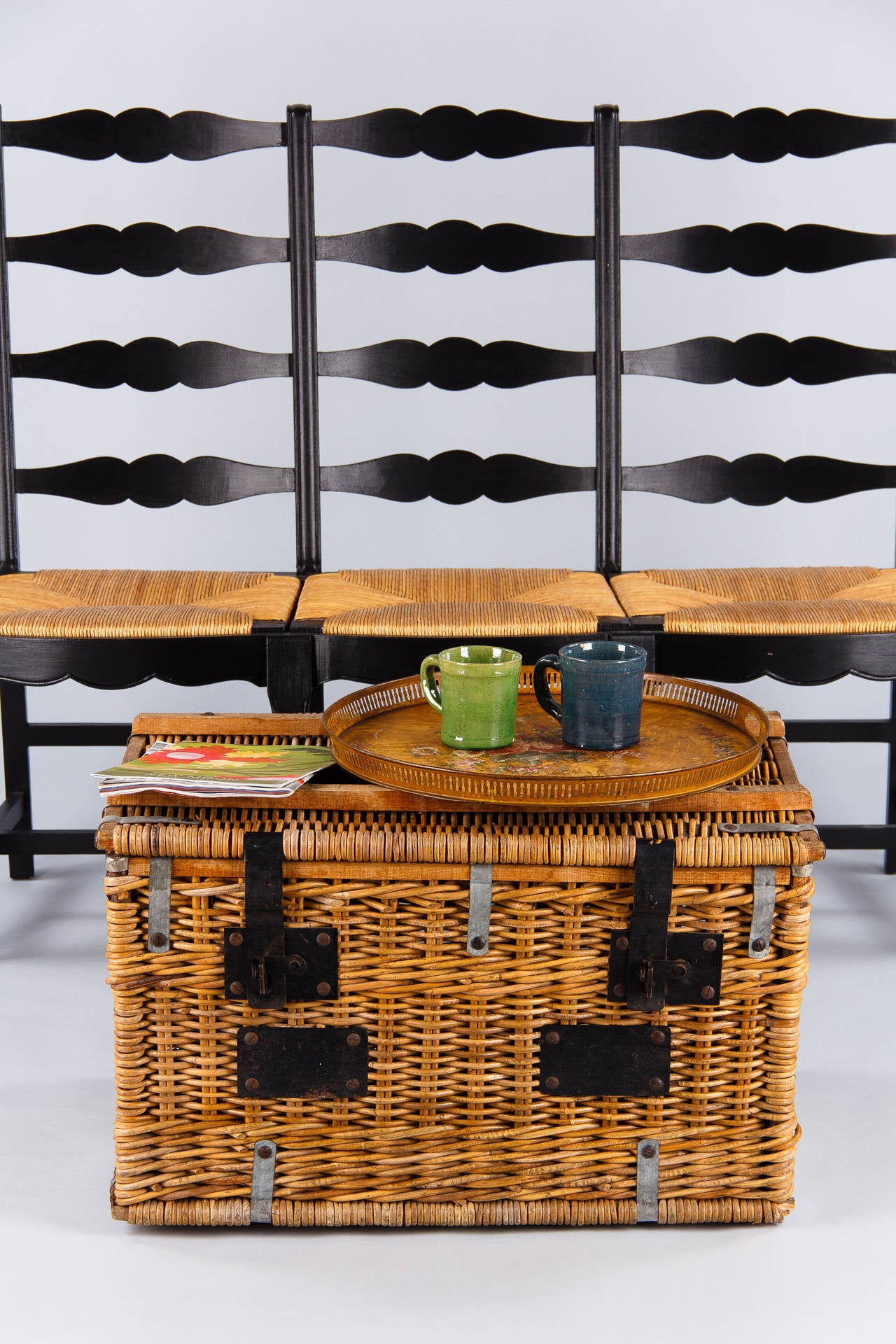 A traveling trunk from the Rhone Region made of wicker with black iron locks and handles. A great piece for storage or as a coffee table!