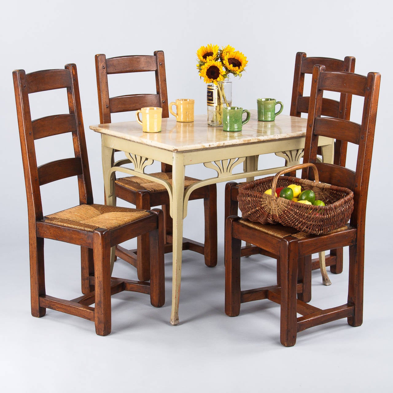 A set of four Country French Chairs from Provence made of oak and featuring removable rush seats. The Chairs have clean lines, high ladder backs and H-shaped stretchers.