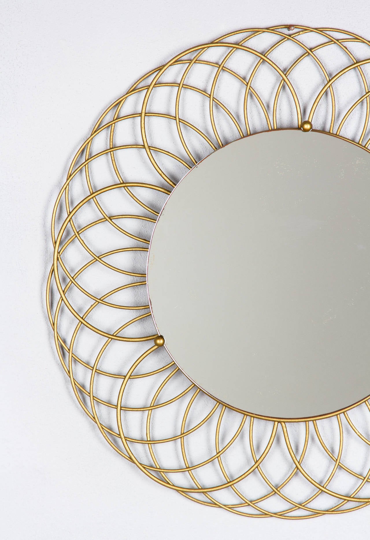 A very decorative French 1960s round mirror with a spiral design brass frame. The mirrored glass itself is 12
