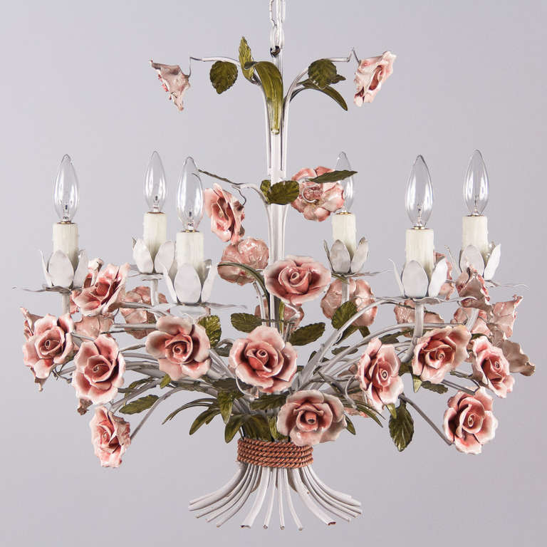 A six-light basket chandelier in painted white tole with delicate porcelain roses and a rope motif at bottom. Made in Italy, with the actual adjustable chain and canopy the chandelier is 46