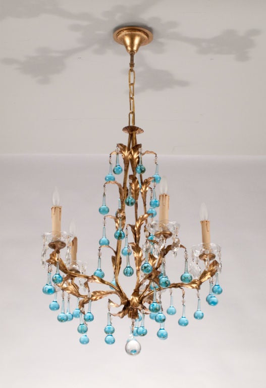 A lovely 5-light Chandelier from Italy with blue tear drop and clear crystal pendants. The fixture is made of brass with leaf motifs. An adjustable chain and canopy extends to 36