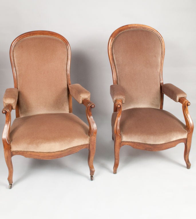 These Louis Philippe period Armchairs were named after the French philosopher Voltaire, who had the reputation to write night and day.  That is why these Armchairs have a 3 position reclining mechanism under the padded armrests. The frame is made of