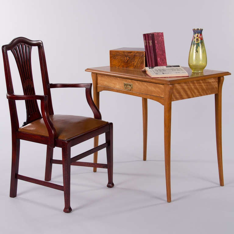 A very comfortable pair of armchairs made in Paris in the 1940s by Lacour Freres. The chairs are English Chippendale style made of red mahogany with curved armrests and open backs with pierced slats. The removable cushions are tobacco brown leather.