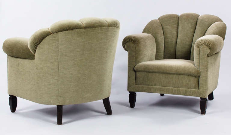 This terrific Pair of French 1940's Armchairs sport a comfortable anise green upholstery and ebonized wooden feet.. The armchairs have rounded channel backs accented by curved armrests. Beautiful lines from all angles. A great find...and very