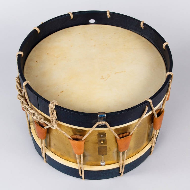 The Town Crier was a popular figure in France villages and his instrument of choice was the Drum. Some Town Criers still exist as an honorary appointment. This Drum from the South of France is made of brass with a black wooden trim, rope and goat