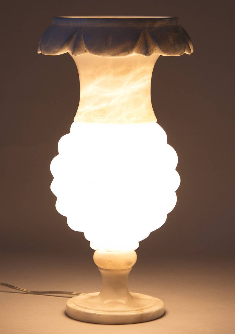 A tall and elegant urn shaped Torchere Lamp in alabaster from the 1940's. The lamp takes a regular bulb up to 60w.