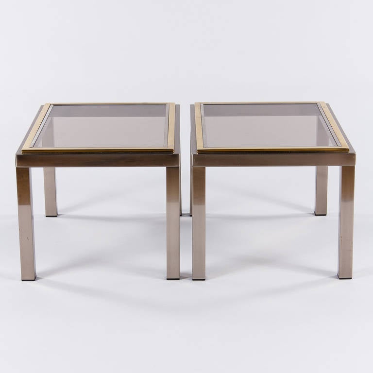 A fabulous pair of vintage French side tables made of chrome plate with brass trim from Lyon, circa 1970s. The removable top is smoked glass with a chrome edge. 

Note: Tables can be sold separately at $1,500 each.