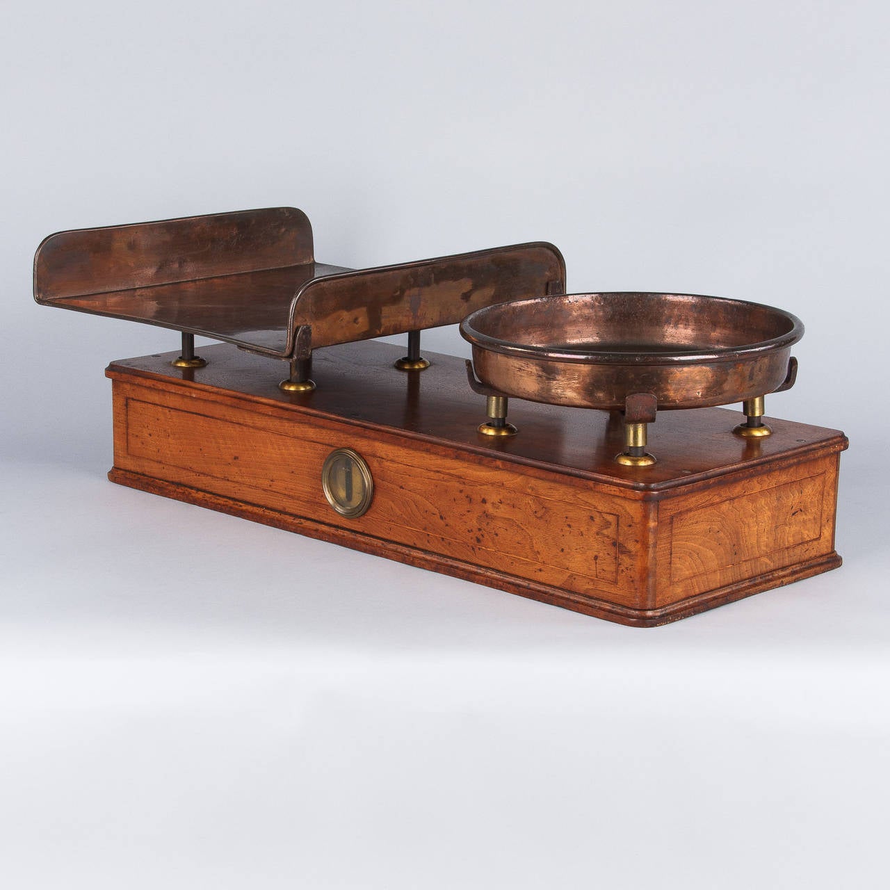 A wonderful scale from a silk traders factory in Lyon. This large scale dates from the Louis Philippe period, mid-1800s and is made of walnut wood with copper pans. The rectangular pan was used for samples of fabric and the round pan for weights. A
