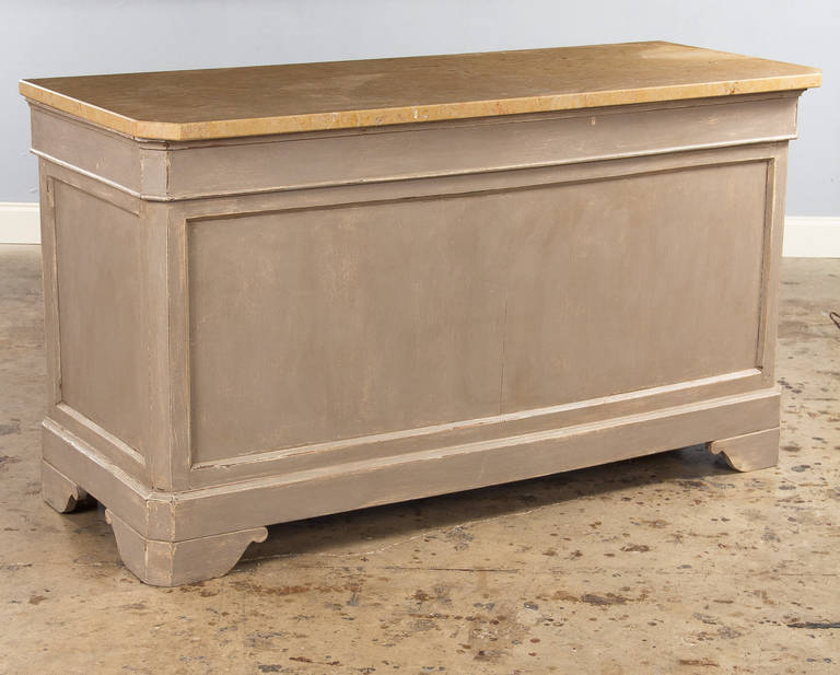 A truly original, absolutely wonderful store counter from a bakery in the Beaujolais Region. This cabinet is made of pine painted in light grey tones and the top is a thick beige granite slab. The front side is paneled and the back side has 2