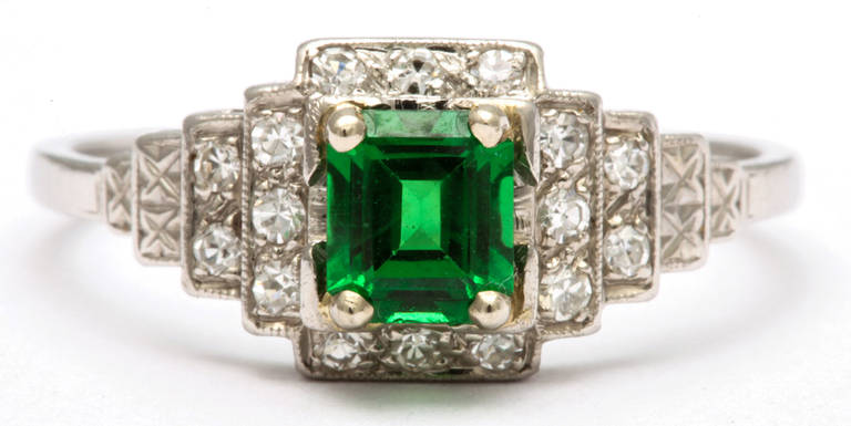 Set in an Art Deco ring, Tsavorite a stone with the color of a fine, saturated emerald, was named by the president of Tiffany and Company in 1973 when it was introduced to North America.  Tsavorite is a clearer stone, more radiant and much hard than