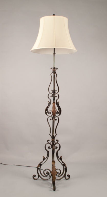 A Mid-century black forged iron Floor Lamp with scrolls and acanthus leaves in copper tones. The actual shade is 20