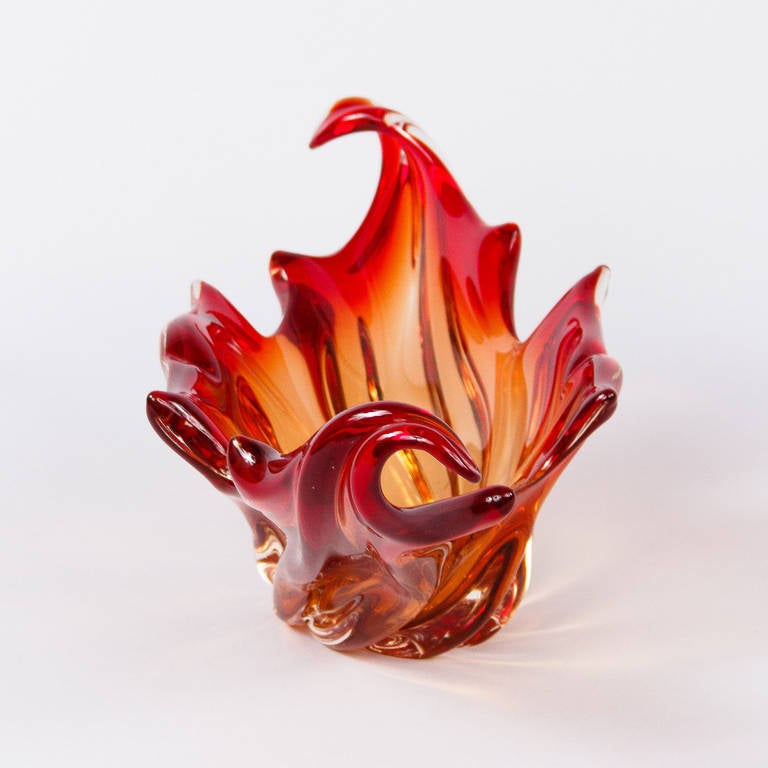 This outstanding and vibrant fire red 1940s French Centerpiece Vase will make a strong statement on a coffee table, dining or console table. With its amber and red tones, it will add pazazz to any home.