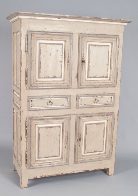 A fabulous French Country 4-Door Oak Armoire lightly distressed and painted in off-white and light grey colors.  A wonderful piece from the Provence Region that dates from the 19th Century.  Perfect for a china cabinet, a linen cabinet or an entry
