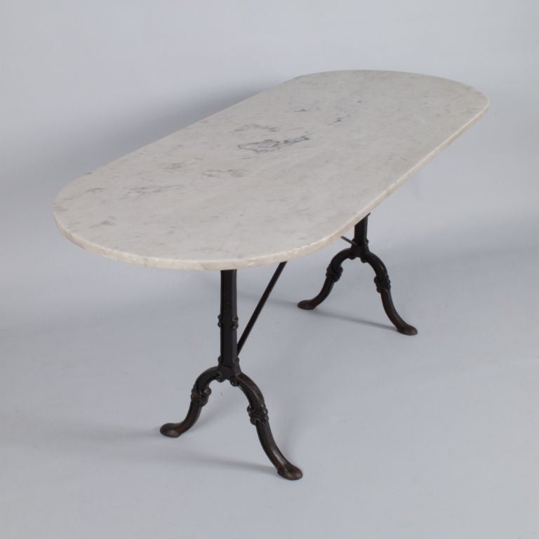 This wonderful antique French Oval Bistro Table is the perfect size.  Long enough for 8 guests and plenty of leg room.  Found in the Bresse Region, this early 1900's Bistro Table has a cast iron base signed by SNES and a beautiful Carrara white