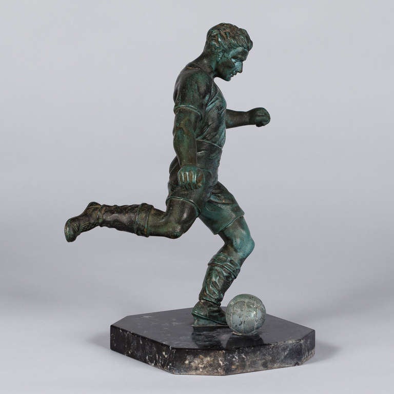 For all soccer lovers, a fabulous 1950s soccer trophy made of patinated green metal alloy on a black marble base.