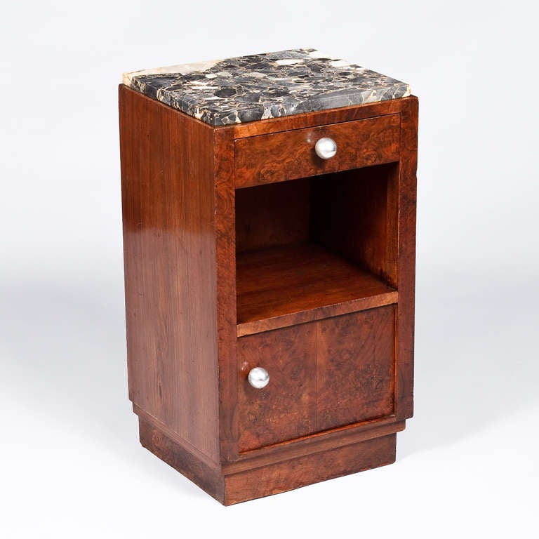 A bedside cabinet from the Art Deco period in rosewood veneer with a black marble top with grey veins. The 