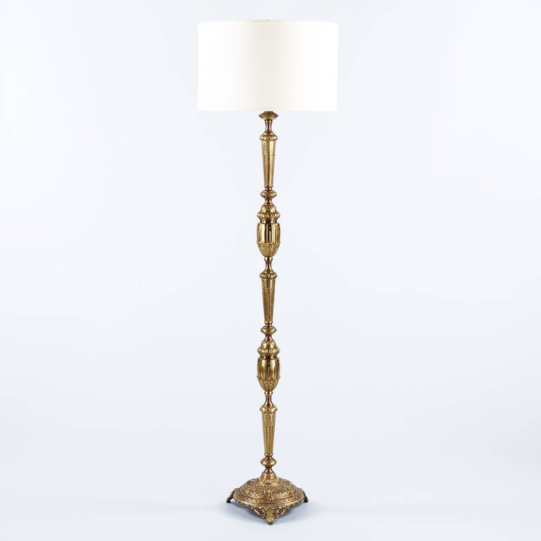 A fancy and beautiful floor lamp in the Louis XVI style made of gilded bronze, circa 1940s. The lamp is very ornate with exquisite sculpted motifs of fluting, beading and water leaves. The round base features interlaces with rosettes.
